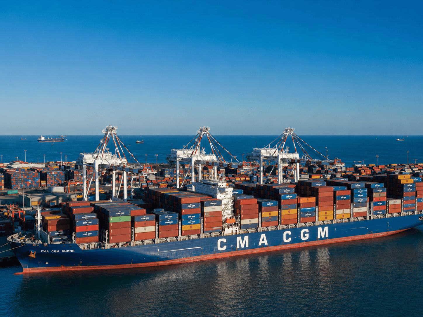 Container ship and cargo plane at a shipping port at sunset
